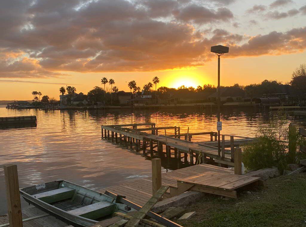 Lake Conroe weekend getaway sunset view from waterfront vacation rental dock near Houston
