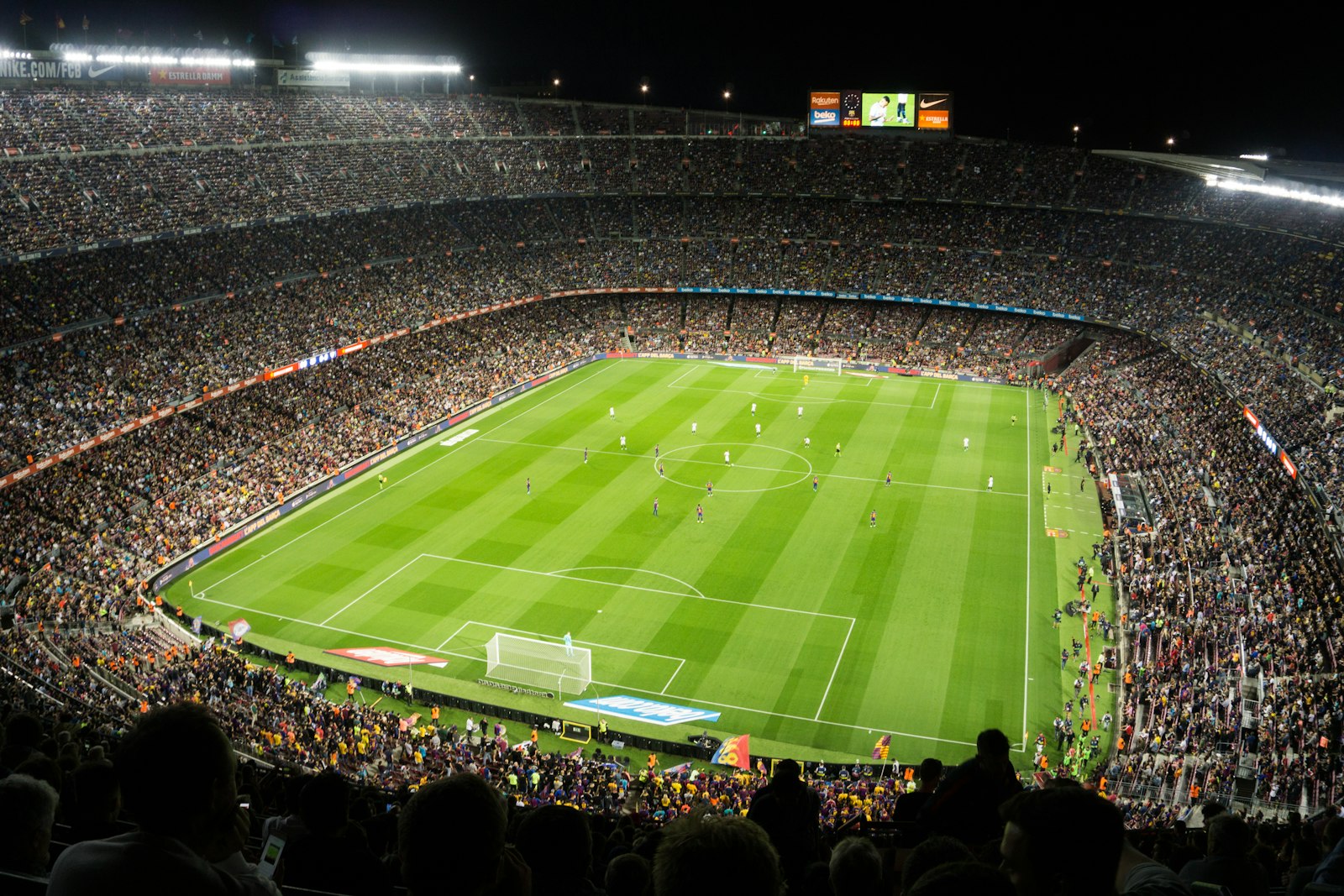 Soccer fans in a packed stadium crowd cheering during a World Cup match