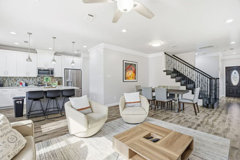 Fully furnished open-concept living room and kitchen in a guest-ready Houston-area short-term rental