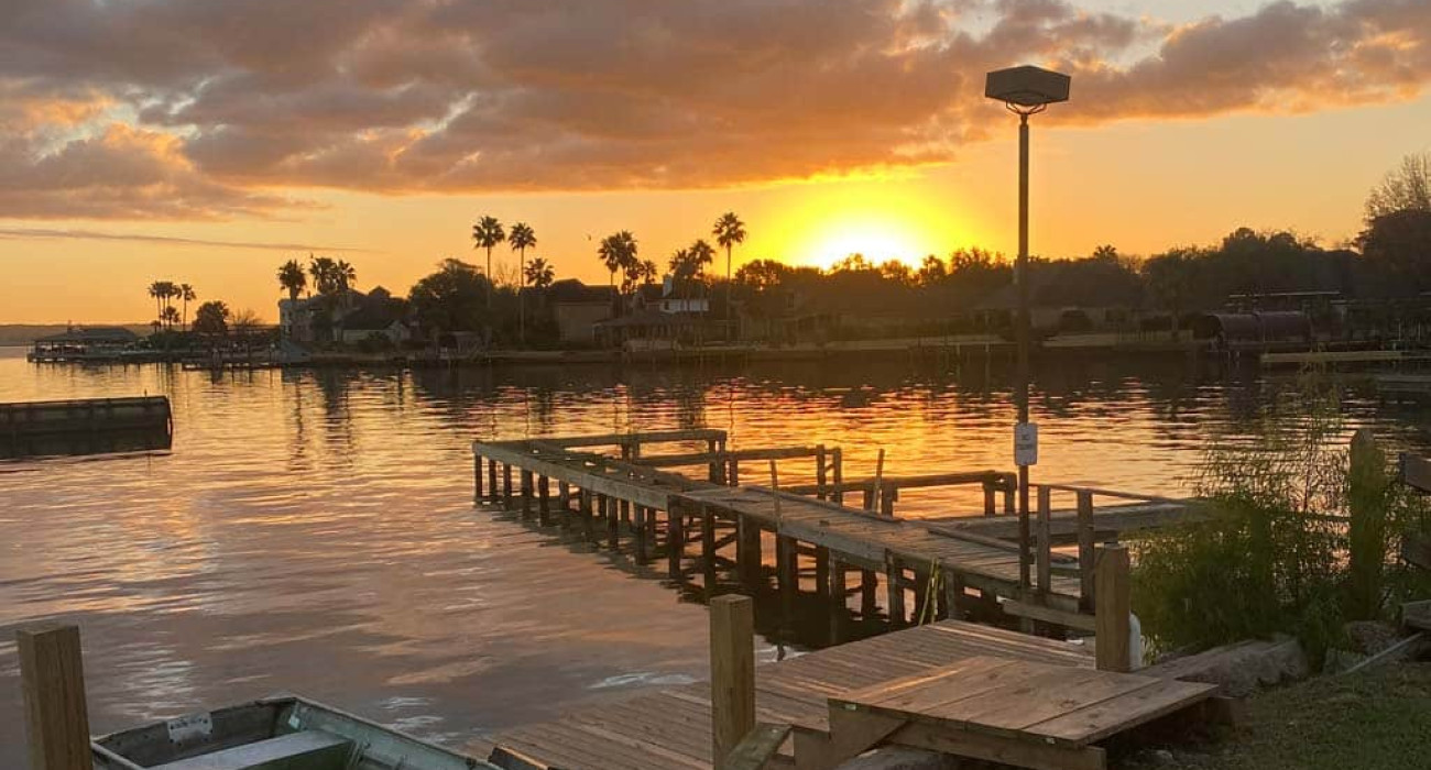 Lake Conroe weekend getaway sunset view from waterfront vacation rental dock near Houston